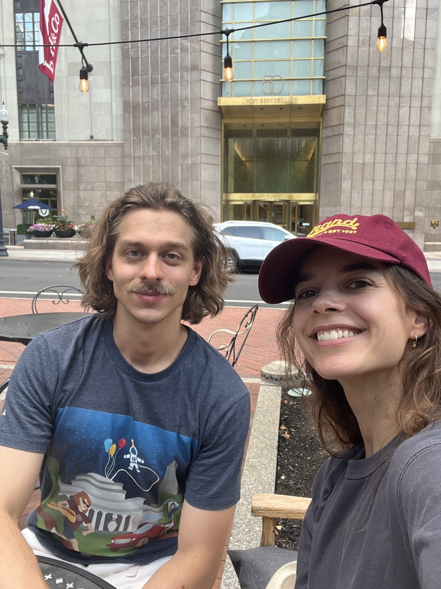 Two CANN lab members smiling outdoors in a city setting.