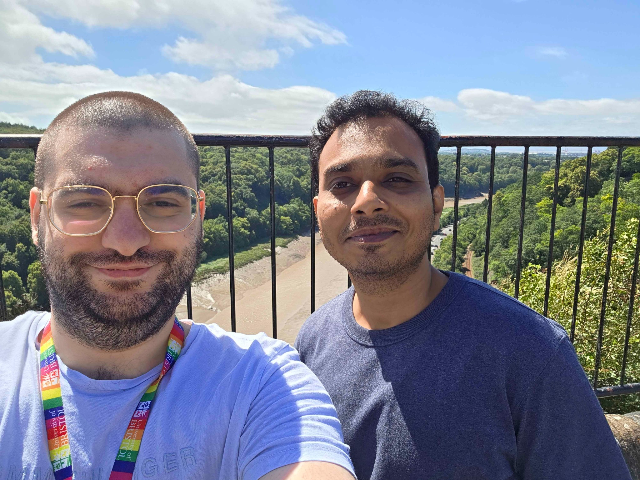 Two CANN lab members taking a selfie outdoors with a river view behind them.