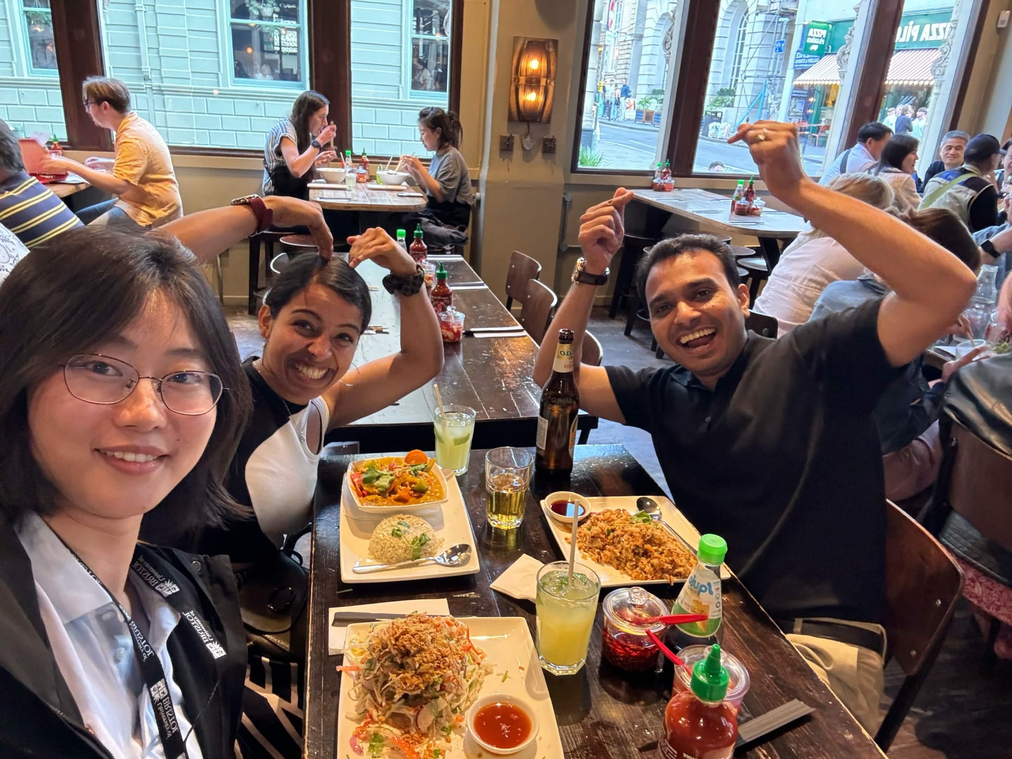 Three CANN lab members sharing a meal in a restaurant.